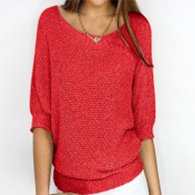 Red sweater worn by a person on a white background