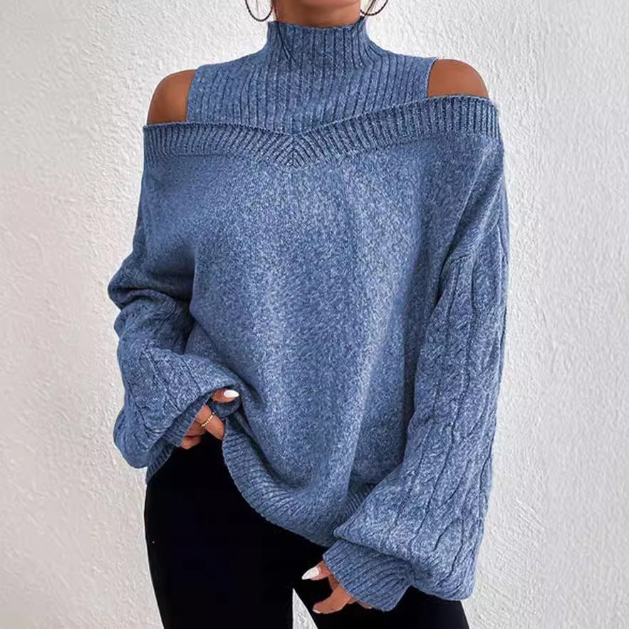Blue sweater with cut-out shoulders worn by a person against a white background