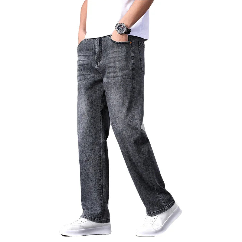Person wearing gray jeans on a white background