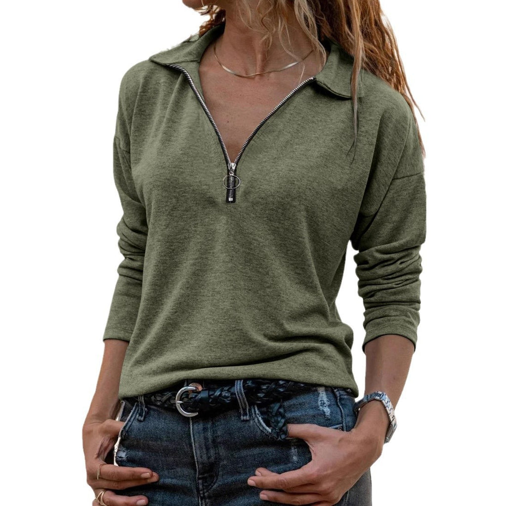 Person wearing a green long-sleeve top with a zipper on a white background