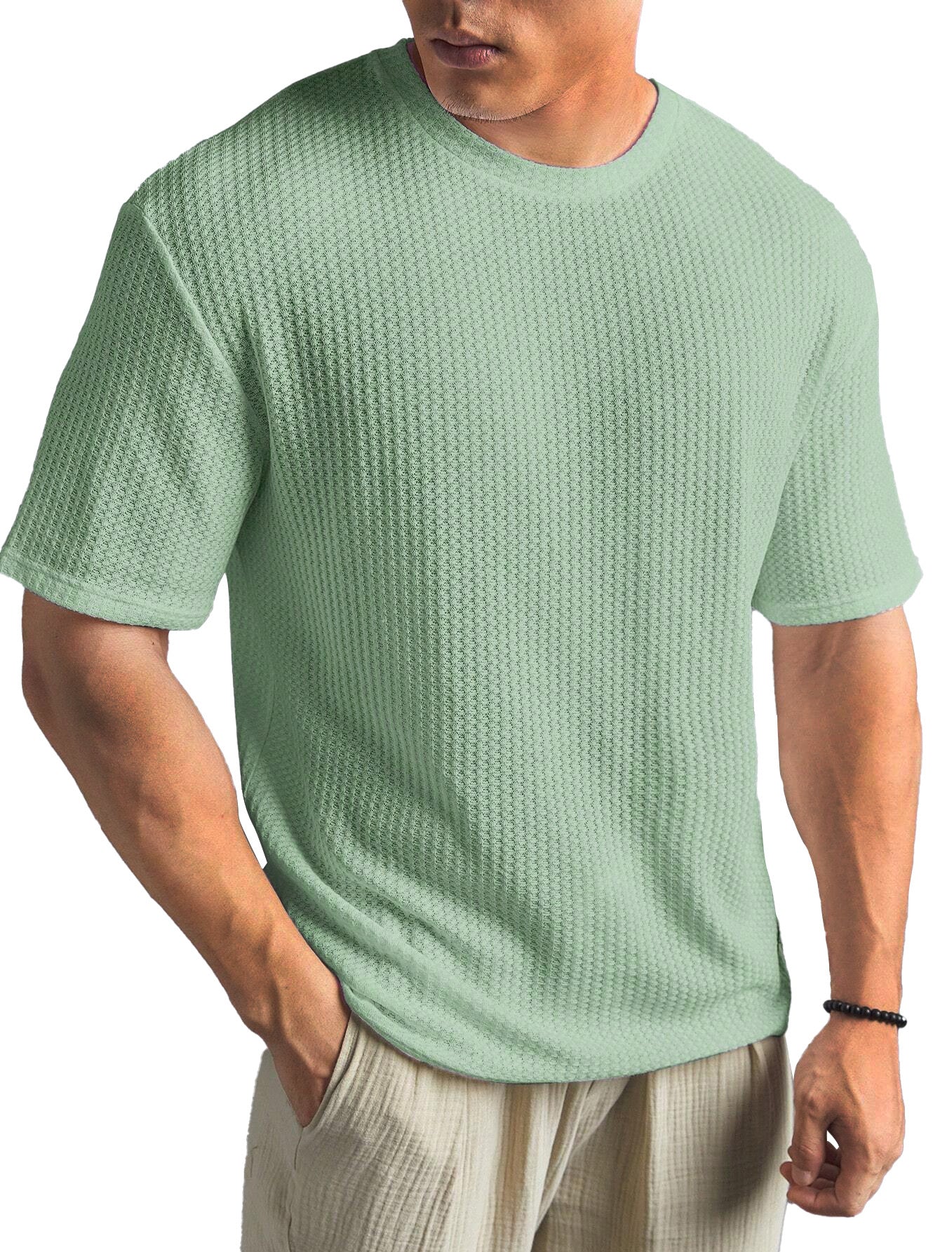 Person wearing a light green textured shirt on a white background