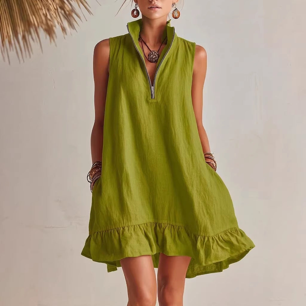 Green sleeveless dress with ruffled hem on a plain background