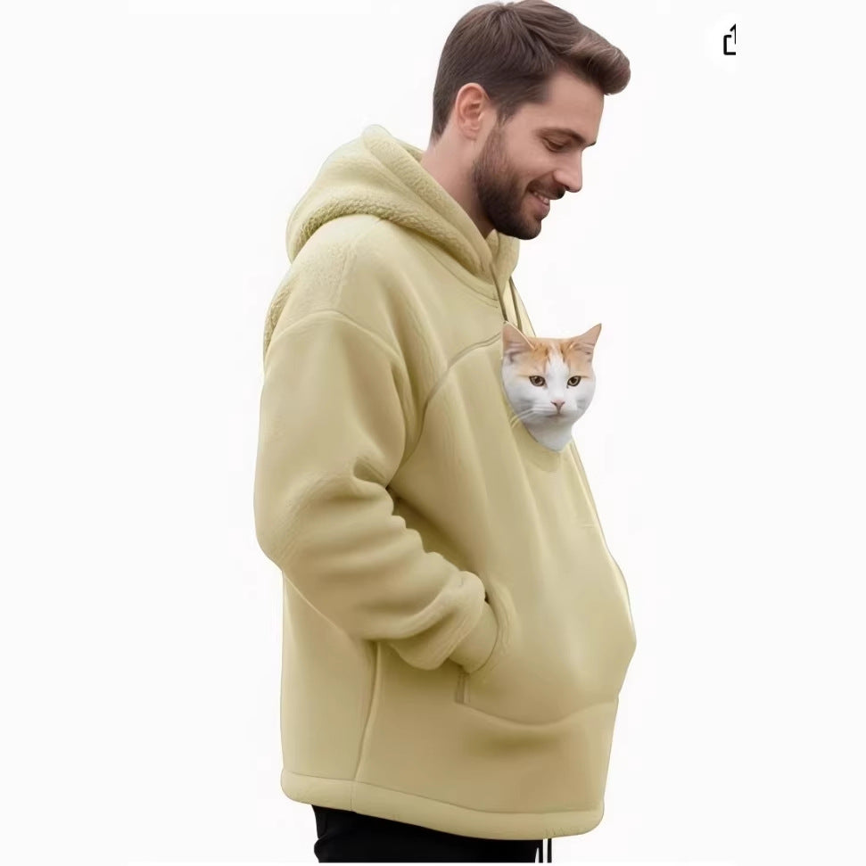 A man wearing a pale yellow sherpa fleece hoodie with a realistic cat printed on the front pocket, shown against a plain white background.
