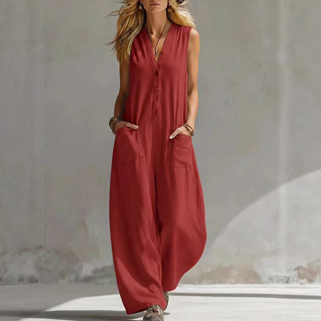 Woman wearing a red sleeveless jumpsuit against a neutral background