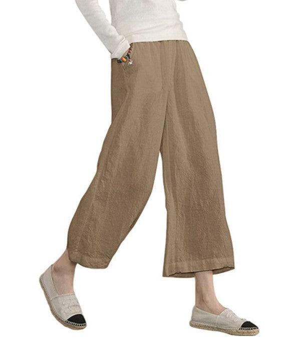 Beige wide-leg pants worn by a person on a white background