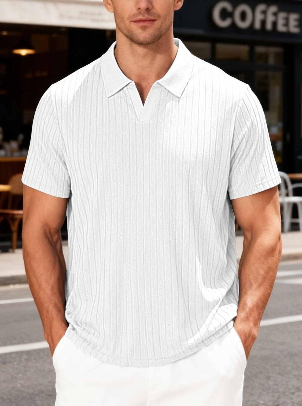 Man wearing a white short-sleeve polo shirt standing outdoors with a blurred background