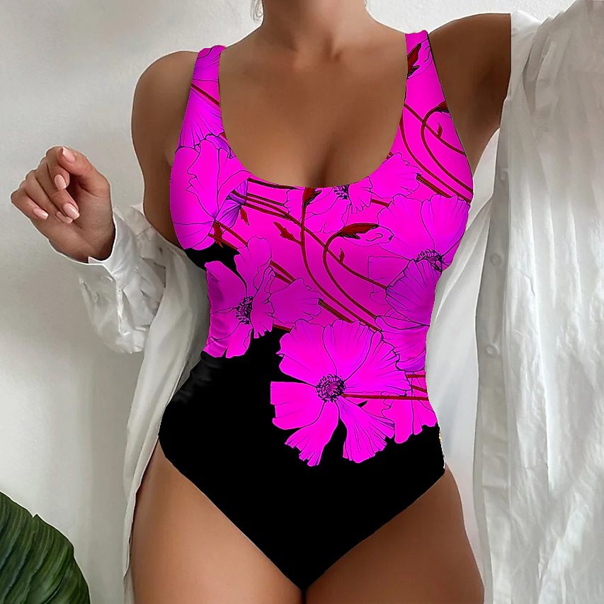 Person wearing a bright pink floral swimsuit against a white background