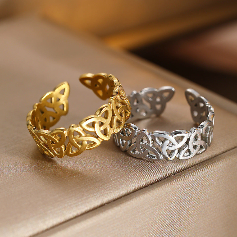 Gold and silver Celtic knot bracelets on a beige fabric background