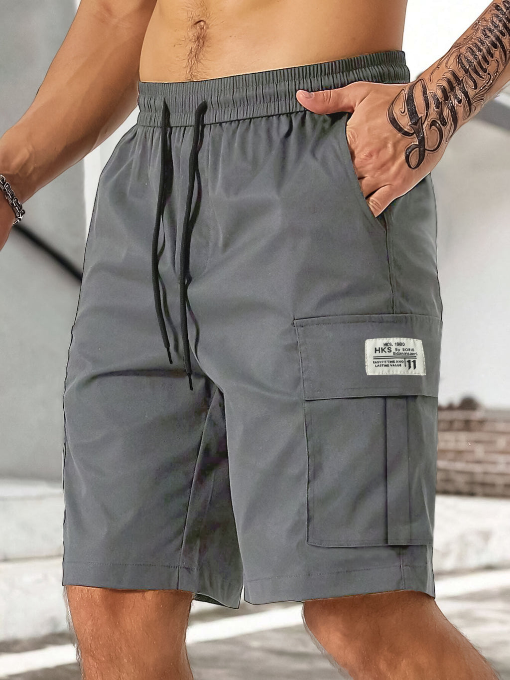 Gray cargo shorts with a brand label worn by a person outdoors.