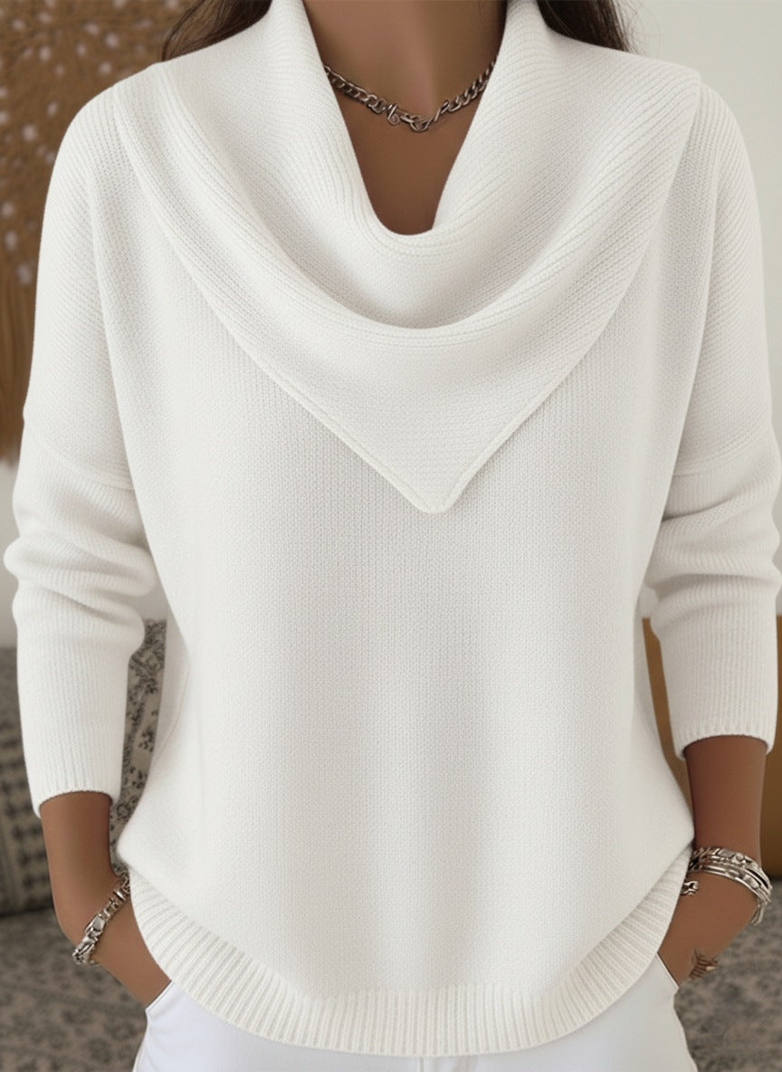 White sweater worn by a person with a neutral background