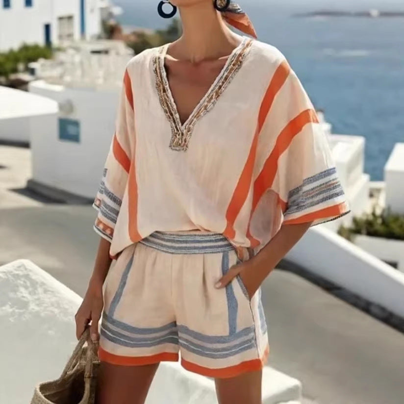 Woman wearing a striped outfit with a scenic background