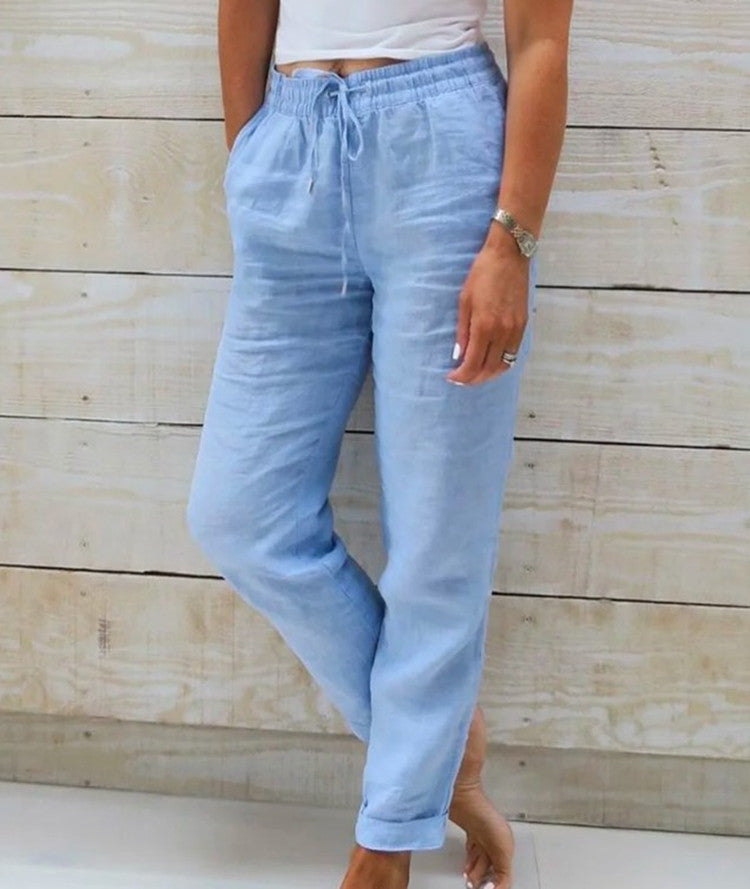 Light blue pants worn by a person against a wooden background