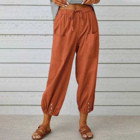 Brown pants worn by a person against a light wooden panel background