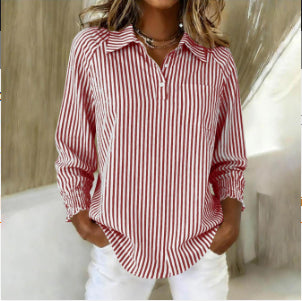 Woman wearing a red and white striped shirt with a blurred background
