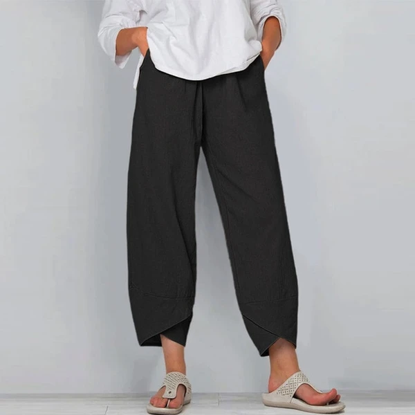 Person wearing black wide-leg pants and a white shirt against a plain background