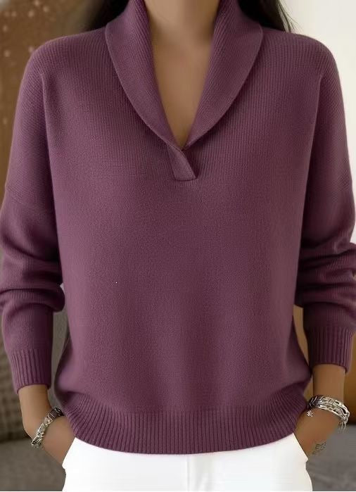 Purple sweater worn by a person with a neutral background