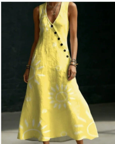 Yellow dress with sun patterns worn by a person on a dark background