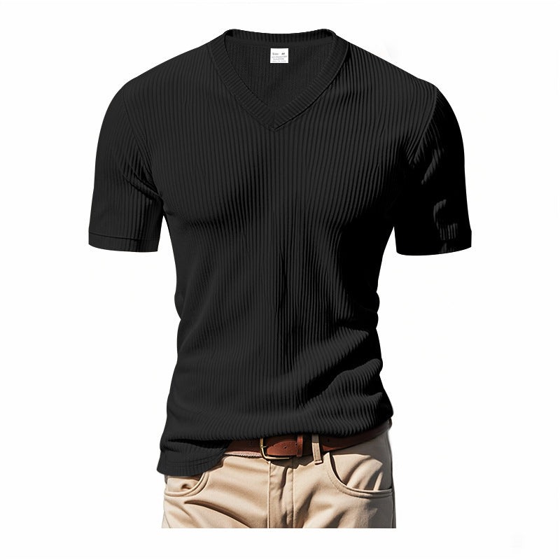 Black V-neck t-shirt worn with beige pants on a white background