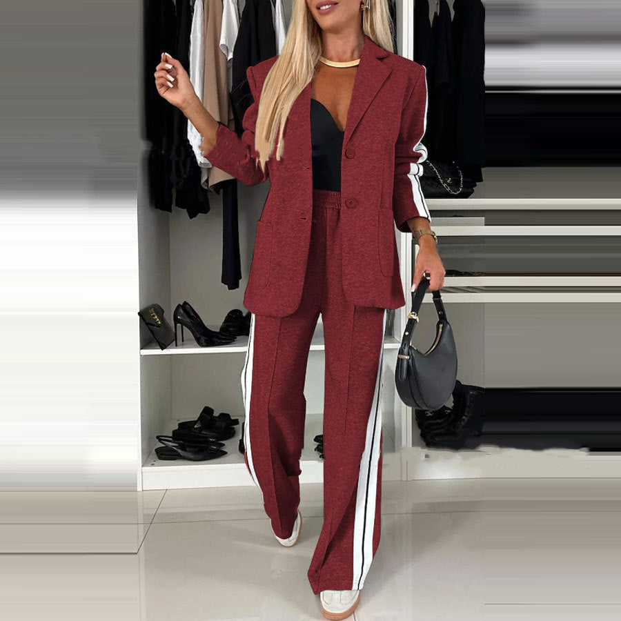 Woman in a red suit with white stripes standing in front of a wardrobe with shoes.