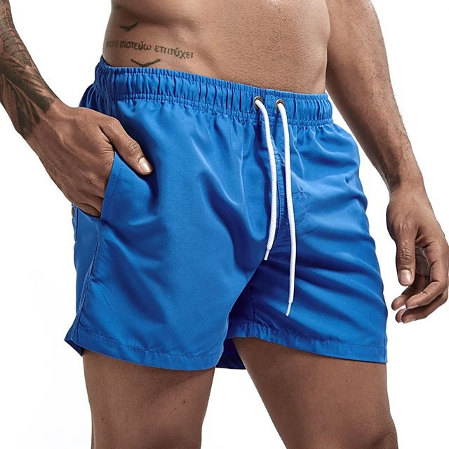 Blue swim shorts with a white drawstring on a white background