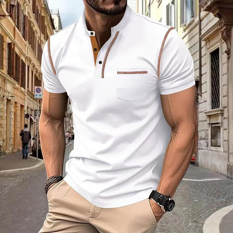Man wearing a white polo shirt with brown accents on a city street.
