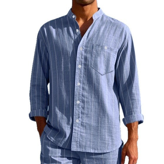 Man wearing a blue striped shirt and pants on a white background
