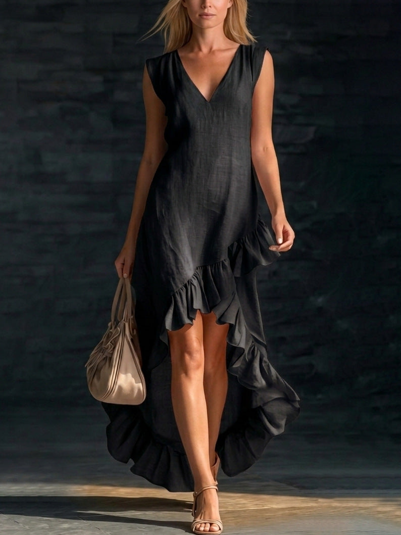 Woman wearing a black dress with ruffles against a dark background
