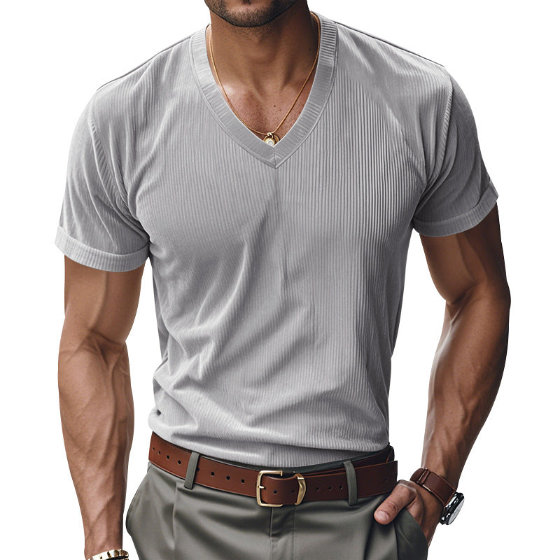 Man wearing a gray ribbed V-neck t-shirt with a brown belt and watch on a white background