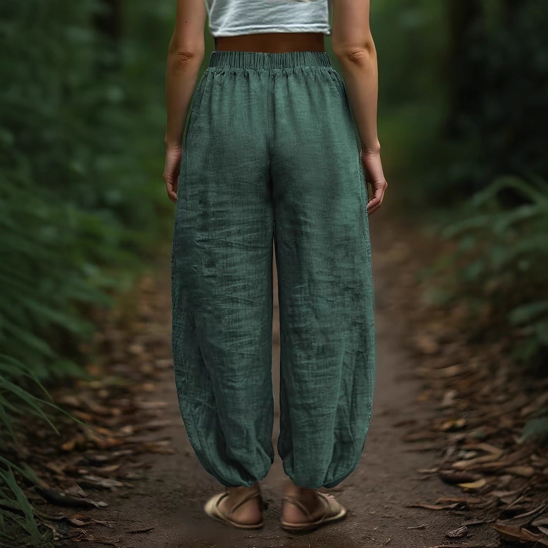 Person wearing green pants standing on a forest path