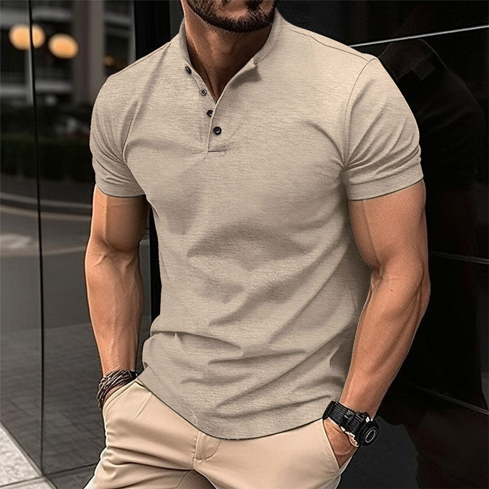 Man wearing a beige polo shirt and pants in an urban setting