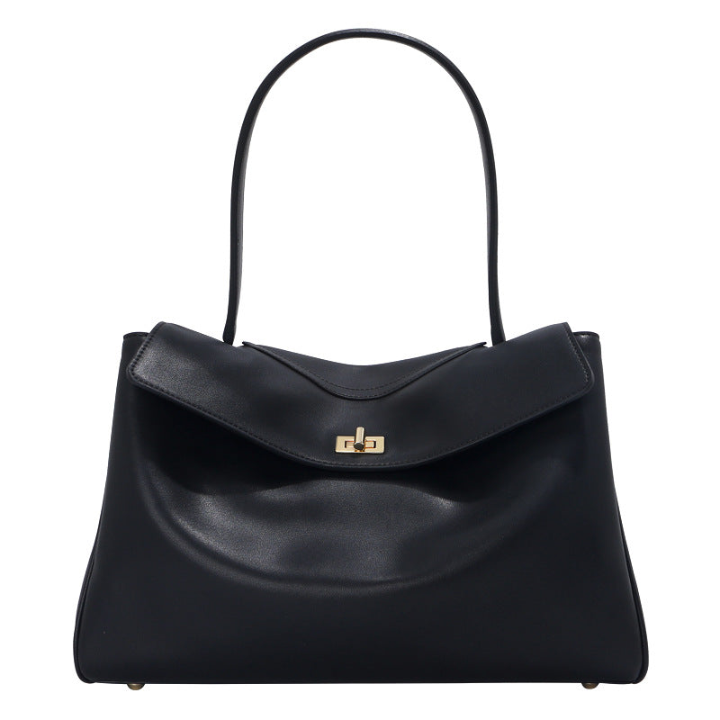 Black handbag with a gold clasp on a white background