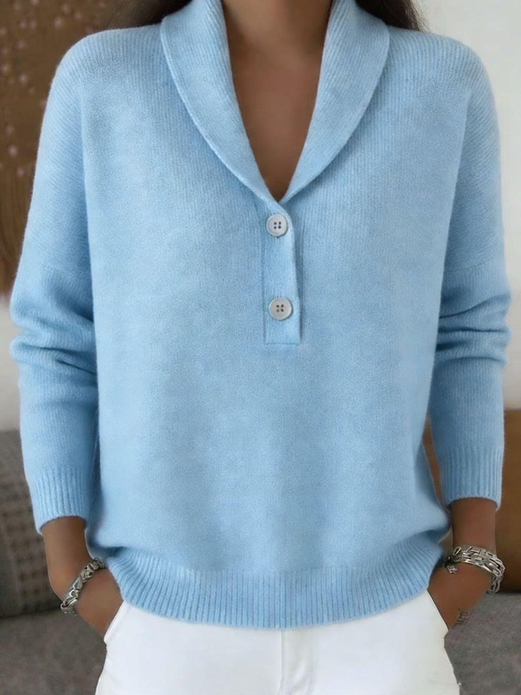 Light blue sweater worn by a person with a neutral background
