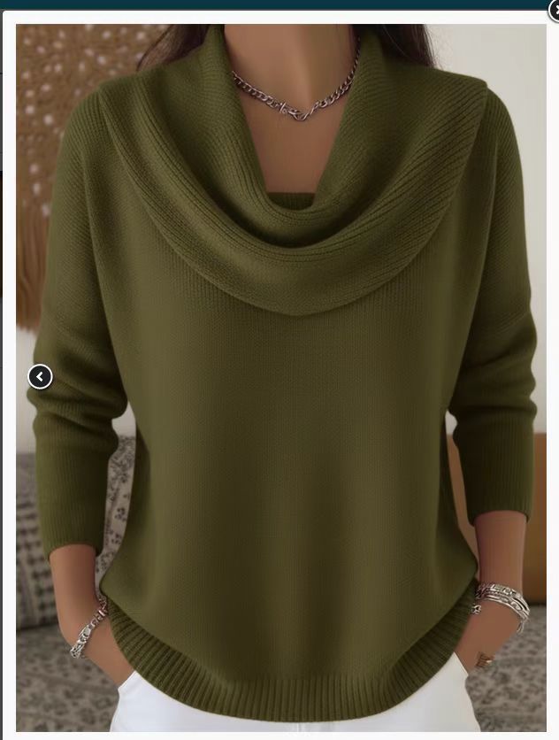 Person wearing a green sweater with a cowl neck in an indoor setting
