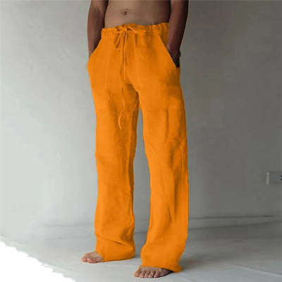 Orange pants worn by a person on a plain background