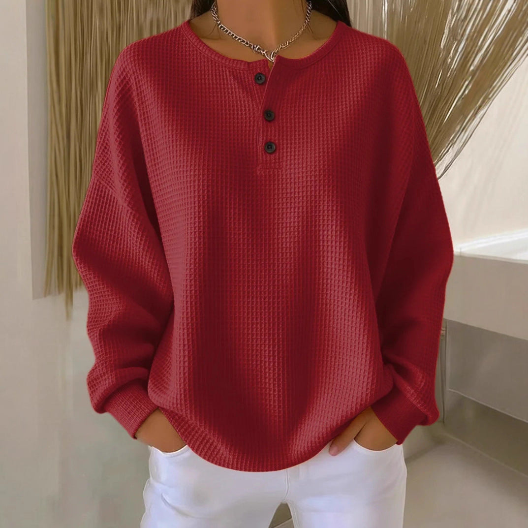 Red textured sweater worn by a person with a neutral background