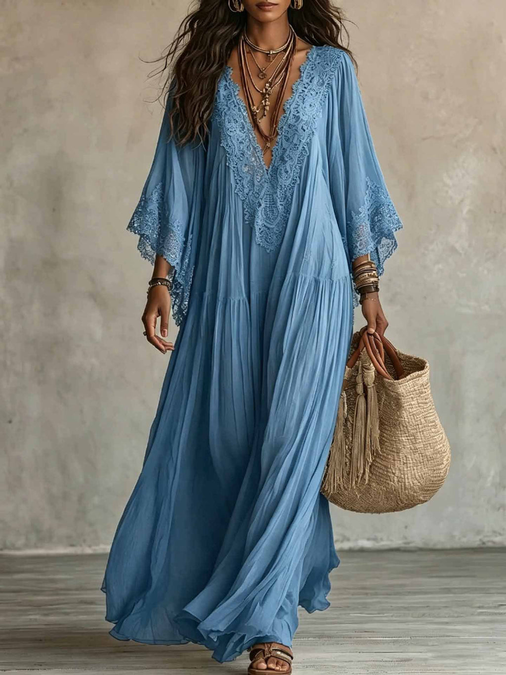 Woman wearing a blue dress with lace detailing, holding a woven bag against a neutral background.