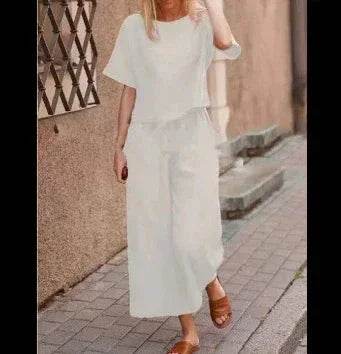 Woman in white chic summer set and sandals walking outside, ZA-Zola trendy fashion UK