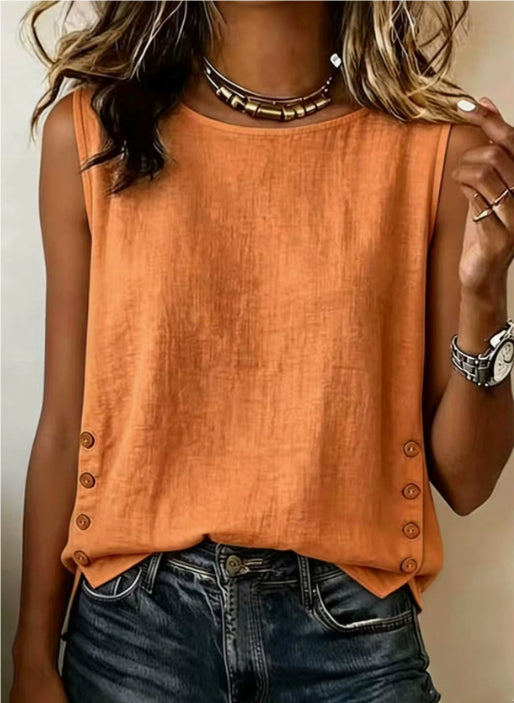 A woman wearing a sleeveless orange top with decorative buttons along the sides and dark blue jeans, shown from the neck down against a plain light background.