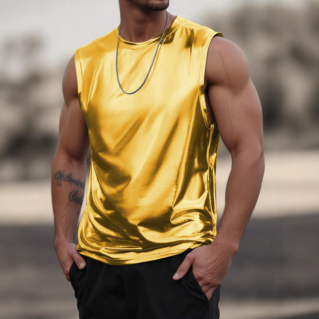 Person wearing a shiny gold tank top with a blurred background