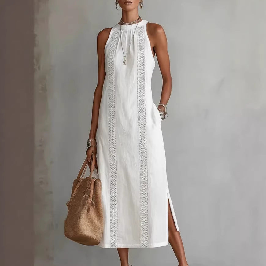 Woman wearing a white dress with lace details and holding a beige handbag against a gray background