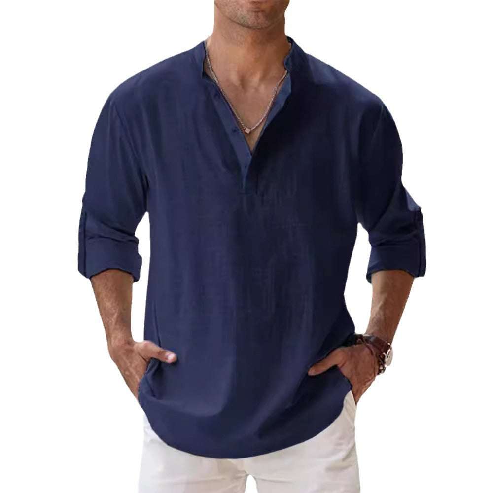 Man wearing a navy blue long-sleeve shirt with rolled-up sleeves on a white background
