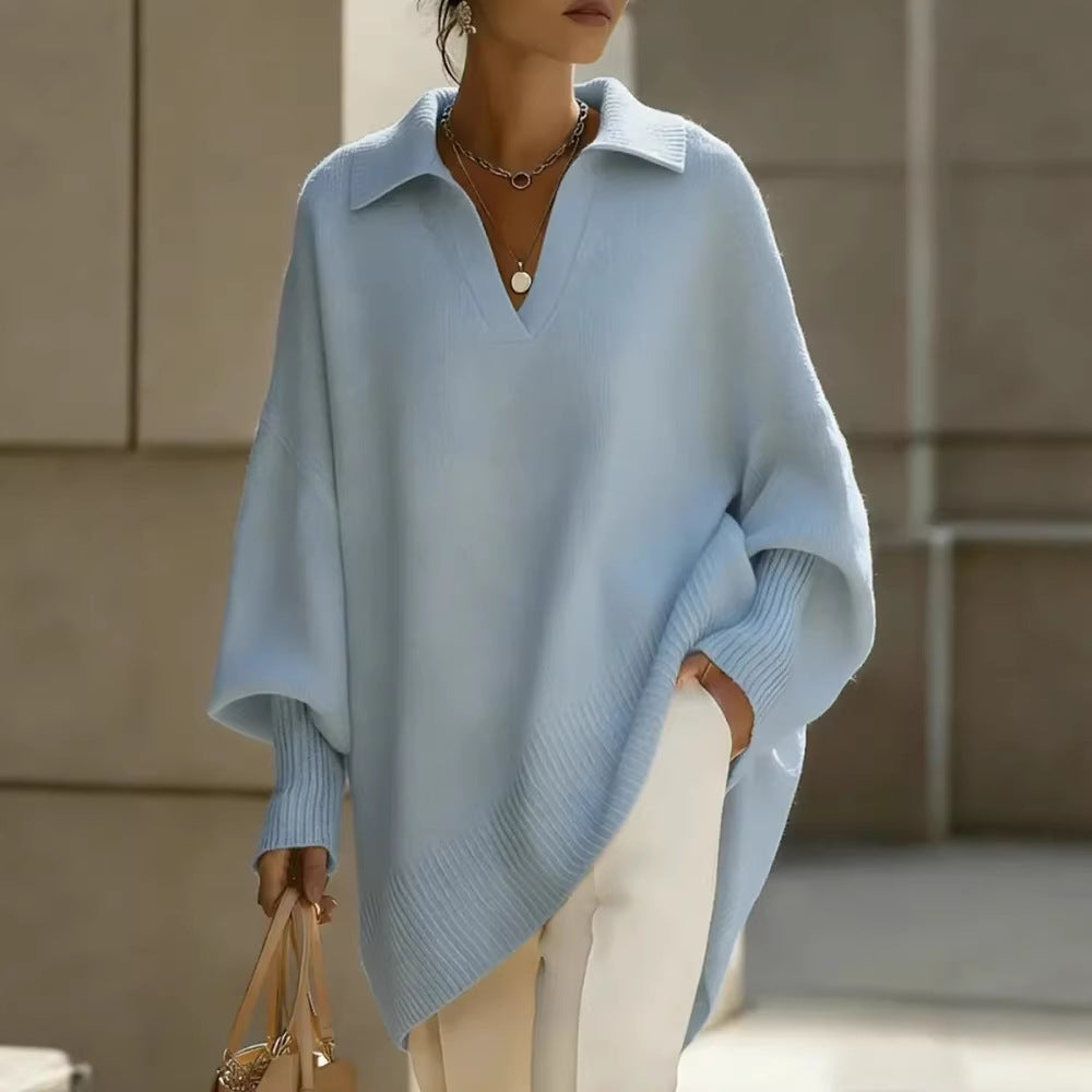 Person wearing a light blue poncho with a neutral background