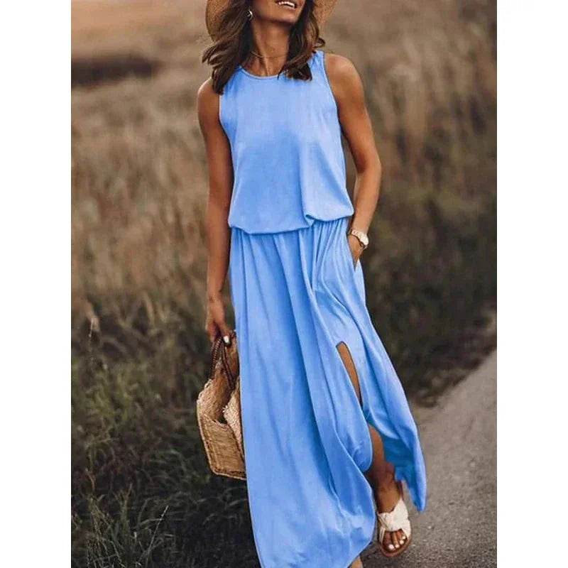 Woman in a sleeveless blue maxi dress from ZA-Zola, holding a straw bag outdoors
