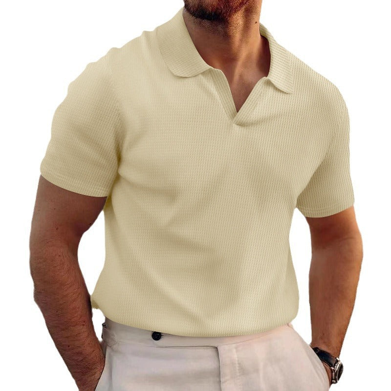 Man wearing a light yellow polo shirt on a white background