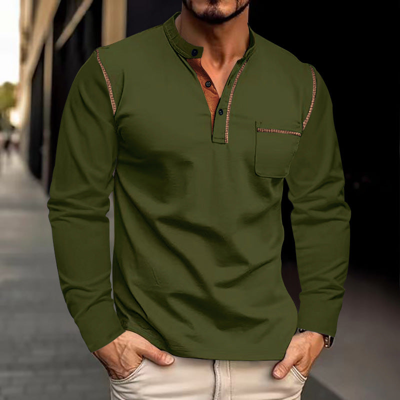 Man wearing a green long-sleeve shirt with a blurred street background