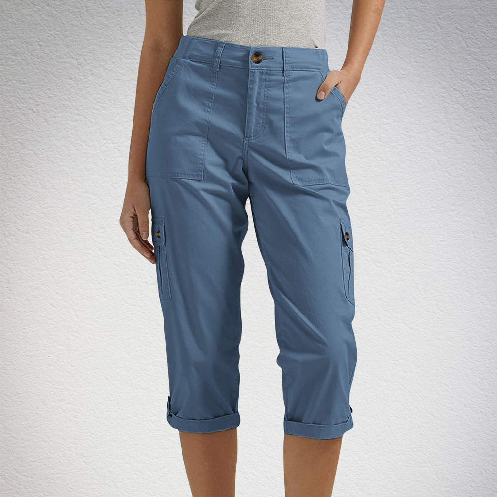 Blue cargo pants worn by a person on a light gray background