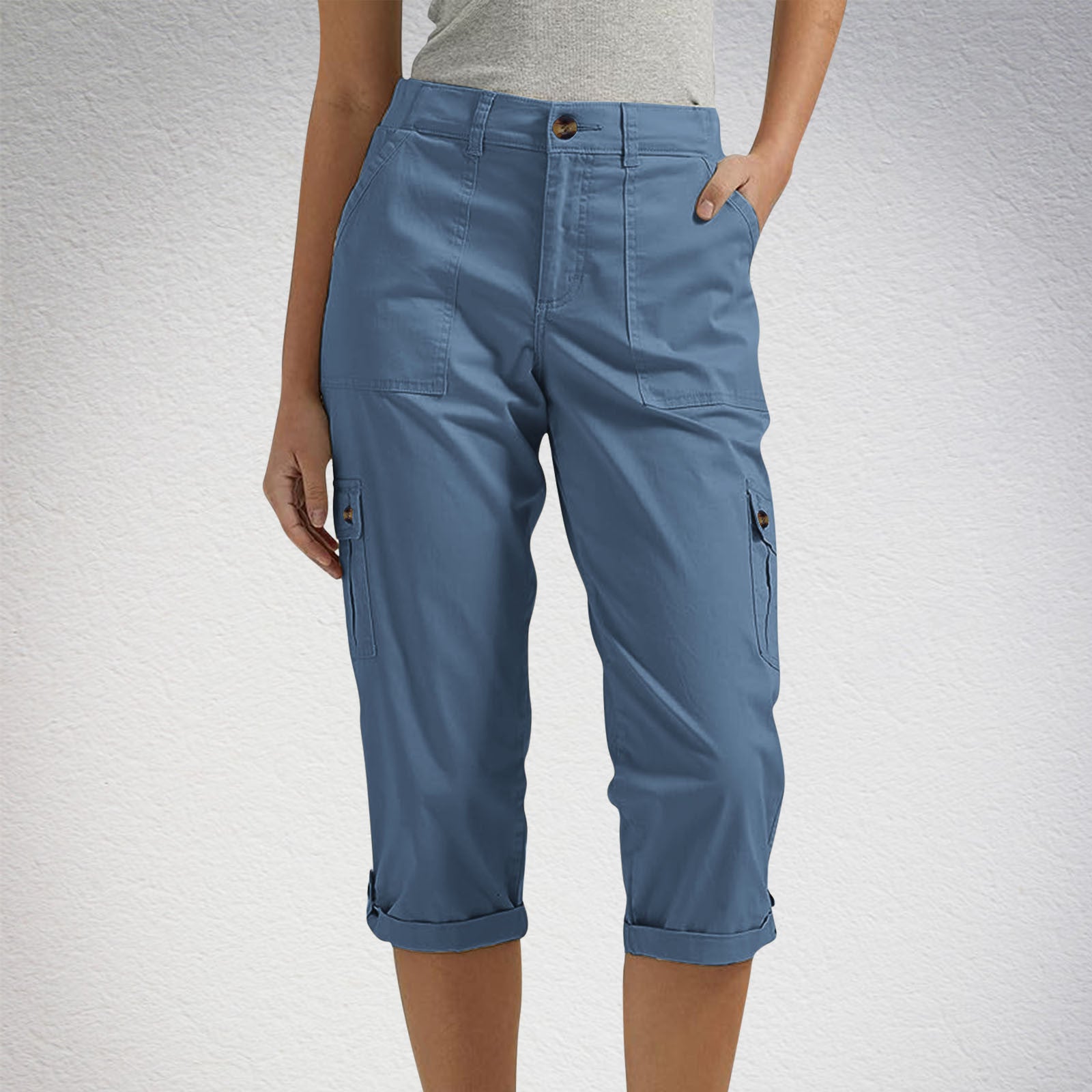 Blue cargo pants worn by a person on a light gray background