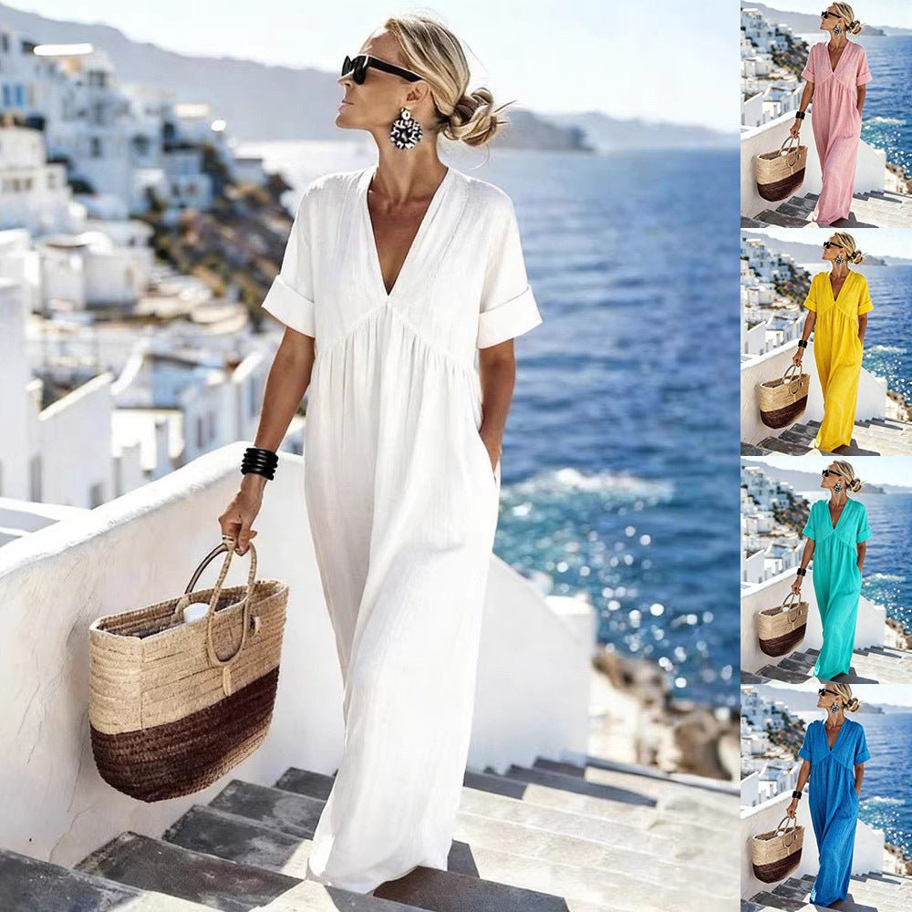 Woman in a white dress with a straw bag against a scenic backdrop