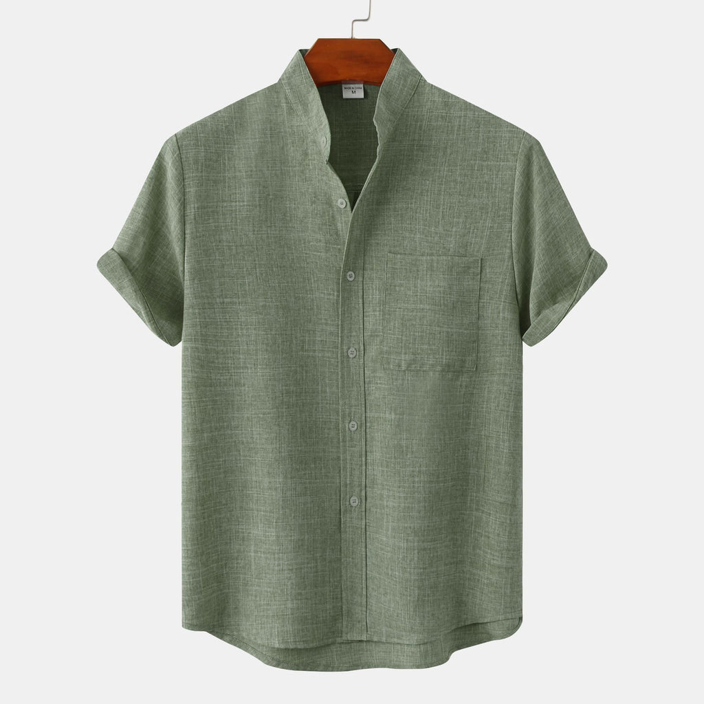 Green short-sleeve shirt on a hanger against a white background