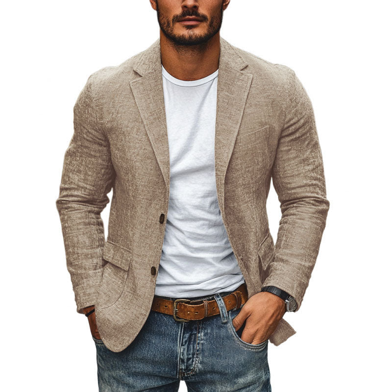Man wearing a beige blazer over a white shirt with blue jeans on a white background